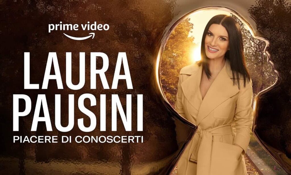 Promotional image of Laura Pausini smiling in a beige coat, standing on a sunlit path, with the title “Laura Pausini – Piacere di Conoscerti” and the Prime Video logo.
