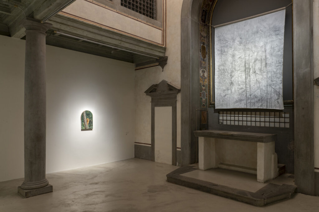 Museo del Novecento in Florence 8 View of Haley Mellin’s installation at Museo Novecento, Florence, featuring a small illuminated painting on the left wall and a large artwork hanging above the former altar. Photo Ela Bialkowska OKNOstudio