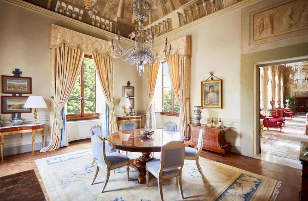 The 7 Best Luxury Hotels in Florence 15 Luxurious suite at Four Seasons Hotel Firenze with elegant chandelier, ornate curtains, and classic Italian furnishings