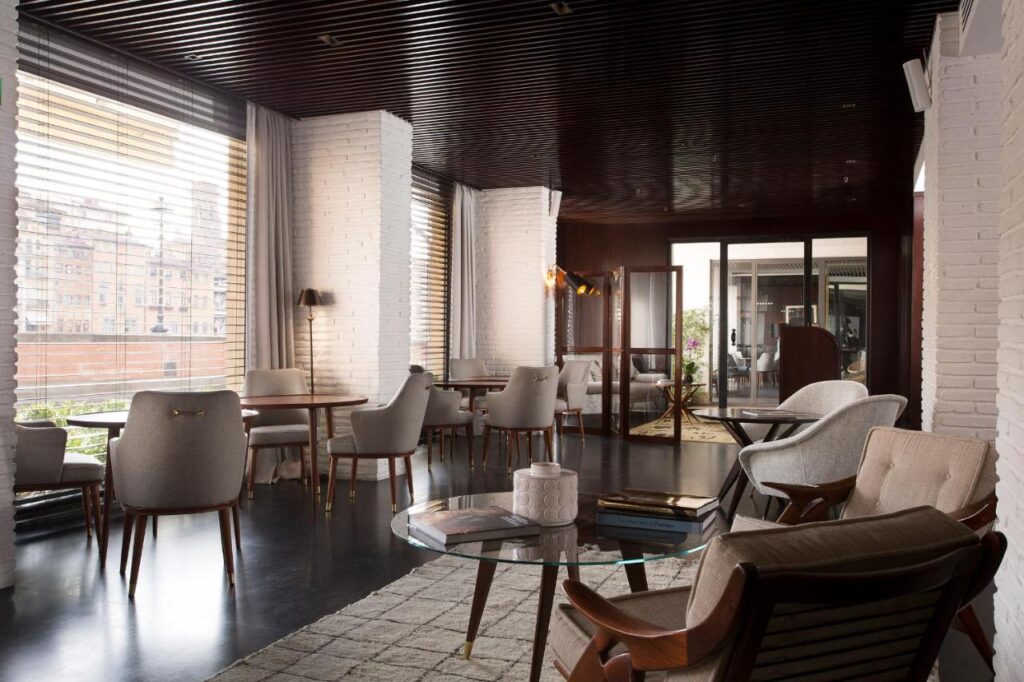 The 7 Best Luxury Hotels in Florence 29 Elegant lounge at Portrait Firenze hotel with modern seating, large windows, and a cozy, sophisticated atmosphere.