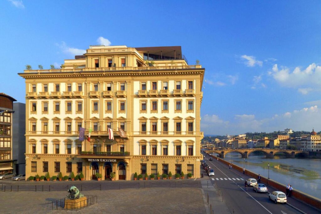 The 7 Best Luxury Hotels in Florence 31 Exterior view of The Westin Excelsior Florence, historic five-star hotel facing the Arno River and city bridges.
