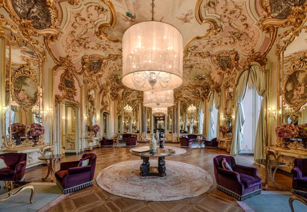 The 7 Best Luxury Hotels in Florence 23 Opulent hall at Villa Cora with gold details, crystal chandeliers, and intricate ceiling frescoes.