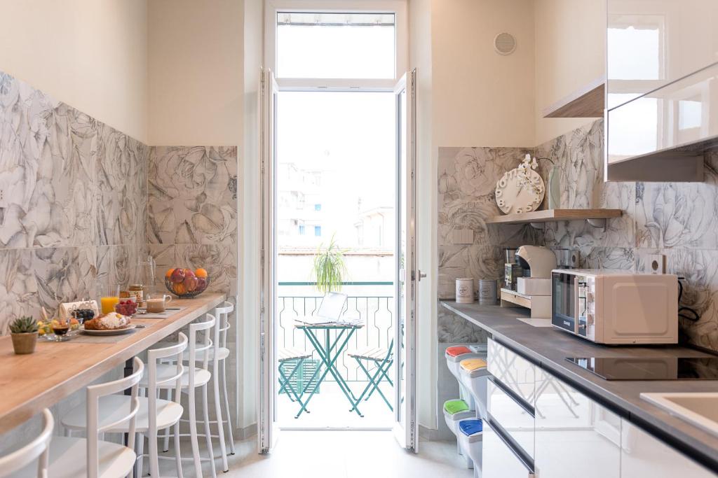 Where to Stay in Follonica: B&B Oltremare, a Top Choice on the Tuscan Coast 6 Modern shared kitchen with breakfast area and balcony at B&B Oltremare, Follonica.