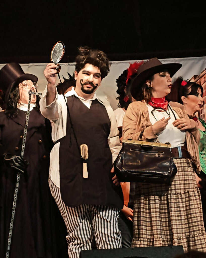 Actor holding a mirror in a comic role during Far far west… Calamity Jane! at San Galgano Abbey, Tuscany