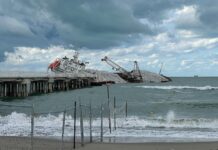 Guang Rong to Leave Marina di Massa Nearly One Year After the Accident Guang Rong cargo ship stranded near the Marina di Massa pier, with construction equipment and stone cargo visible, photographed on September 26, 2025 under cloudy skies.