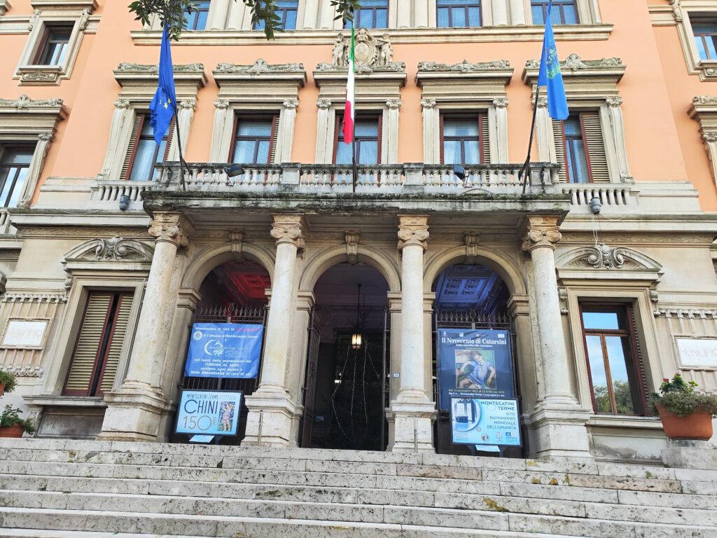 Facade of Montecatini Terme’s Palazzo Comunale with posters promoting the Catarsini exhibition at Mo.C.A.