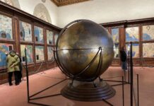 Symphony of Cultures: Music and Intercultural Dialogue at Palazzo Vecchio Symphony of Cultures: Music and Intercultural Dialogue at Palazzo Vecchio - A large historical globe by Egnazio Danti stands in the center of the Hall of Geographical Maps (Sala delle Carte Geografiche) in Palazzo Vecchio, surrounded by wooden cabinets featuring painted Renaissance maps of the world.