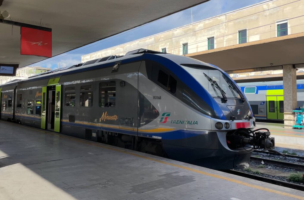 Trenitalia regional train at an Italian station, illustrating the Eurail and Interrail 15% off promotion for rail travel in Europe.