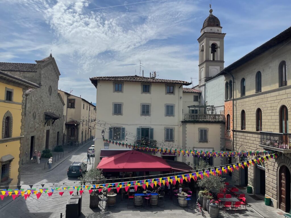 Colorful outdoor café in Borgo San Lorenzo's main square, Mugello, Tuscany — a perfect slow travel destination