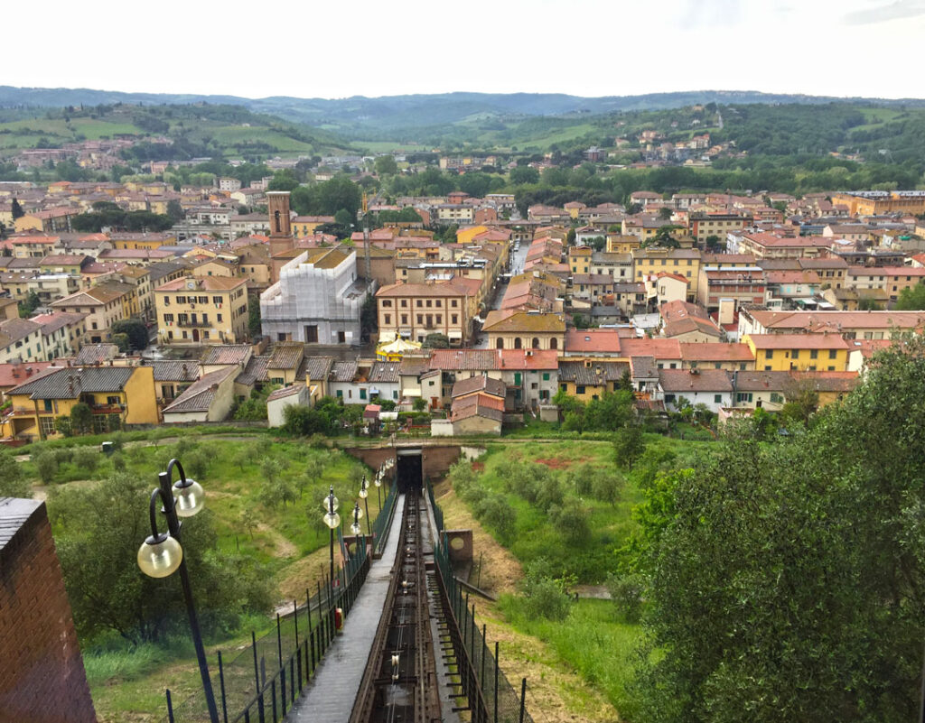 View of the Certaldo funicular tracks descending from Certaldo Alto toward the lower town and Tuscan hills.