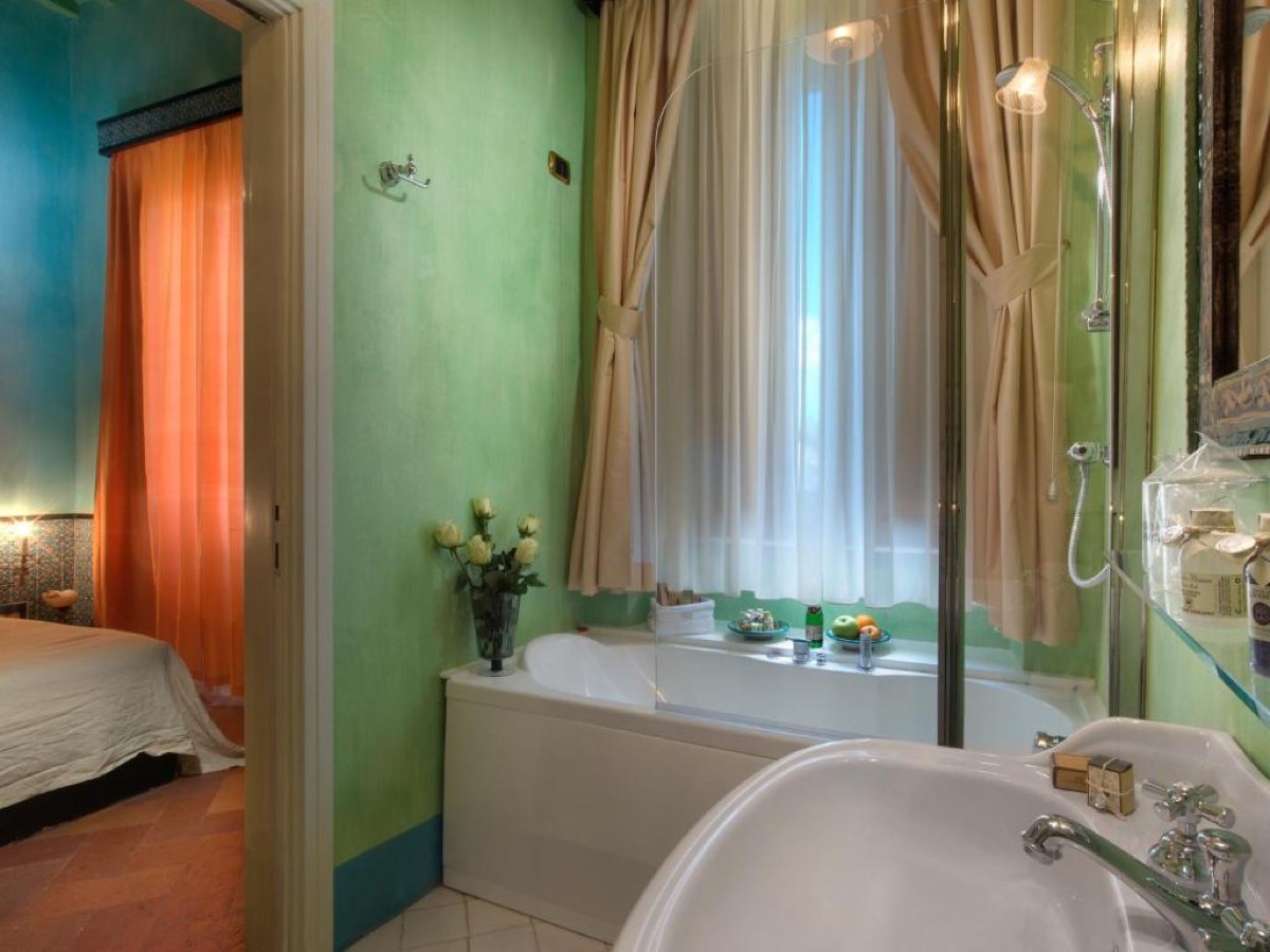 Best Arezzo Hotels for a Memorable Stay in Tuscany 13 Colourful bathroom in a suite at Graziella Patio Hotel, Arezzo
